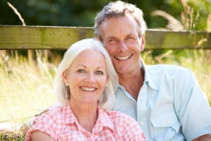 Middle Aged Couple Relaxing In Countryside